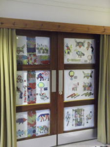 Photo of artwork displayed in doorways at Seaboard Memorial Hall